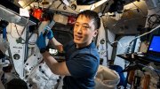 Astronaut performing an experiment inside the International Space Station.