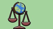 A globe balanced on a pair of scales against a light green background.