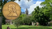 Pulitzer Prize in the foreground with Radcliffe Institute in the background 