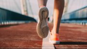 person's shoes while running on a bridge