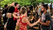 a crowd of people dancing in a street