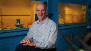 Professor David Mooney in his lab with lab hoods behind him