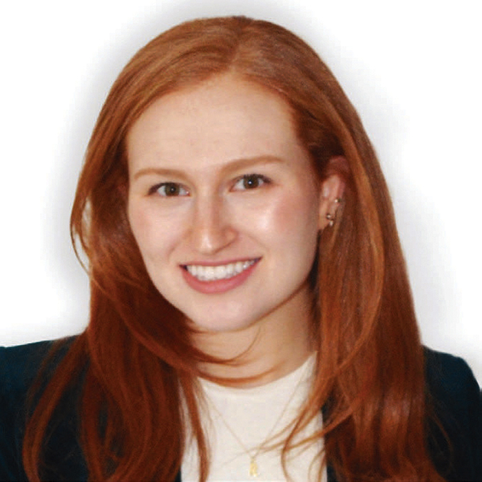 Rachel Janfaza, smiling with long red hair wearing a dark blazer over a white top and necklace.