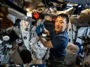 Astronaut performing an experiment inside the International Space Station.