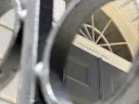 View of a building door labeled "University Hall" through a circular black railing frame.