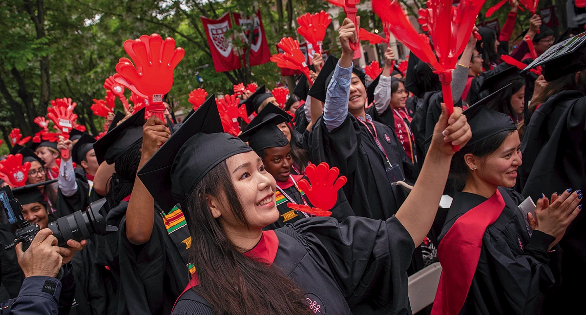 Graduates of the School of Public Health wave helping hands
