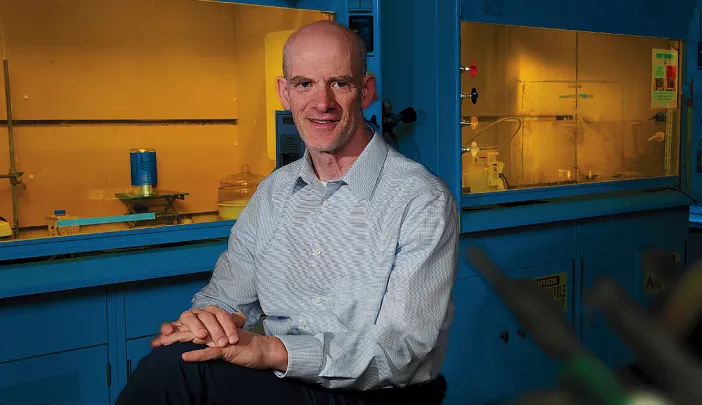 Professor David Mooney in his lab with lab hoods behind him