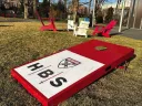 Harvard Business School logo on a campus cornhole board