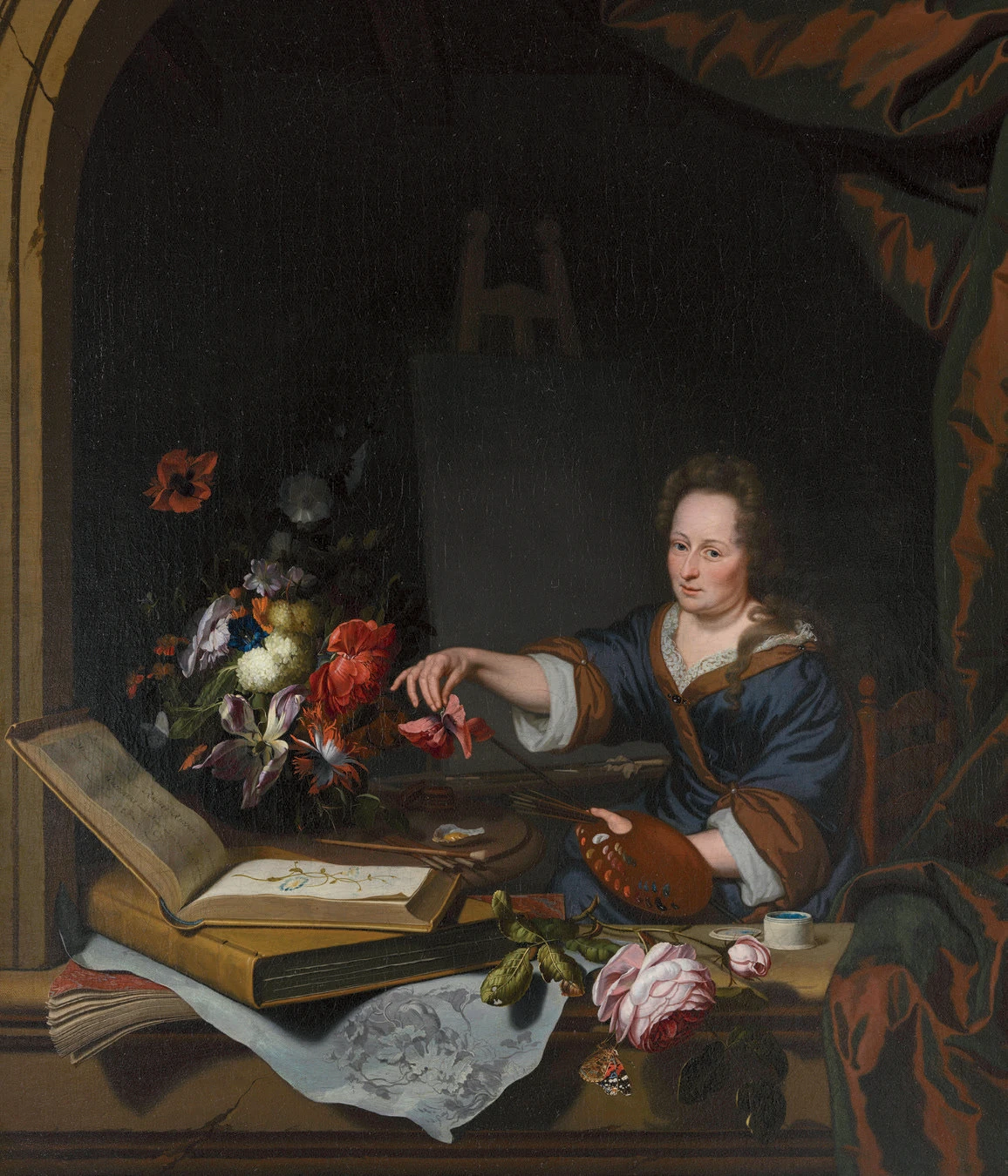 Painting of a woman in a blue dress painting flowers at a table with an open sketchbook and floral arrangement.