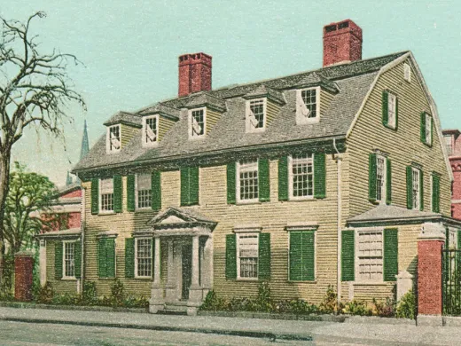Wadsworth House with green shutters and red brick chimneys, surrounded by trees and other buildings.